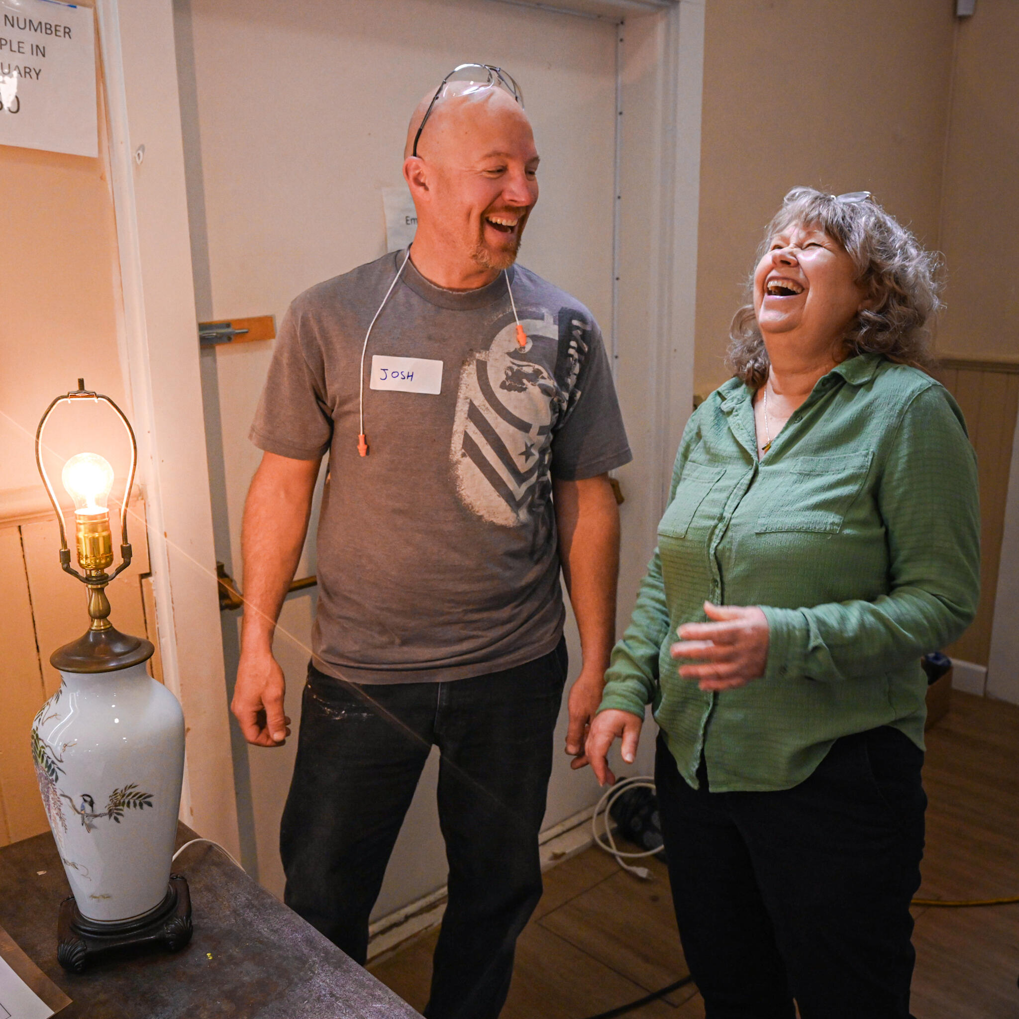 Volunteer interacting with attendee after her light turned back on!